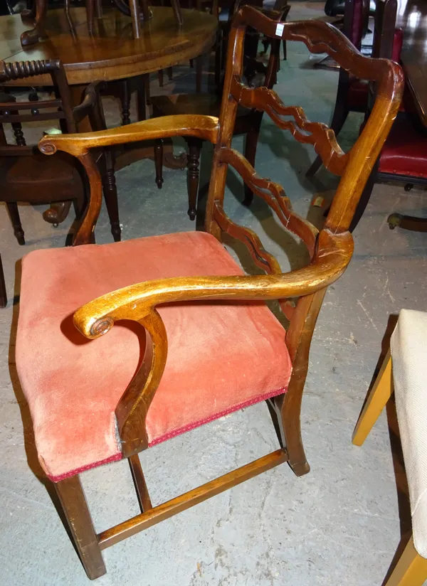 A set of six George II style mahogany wavy ladder back dining chairs, on canted block supports, including a pair of carvers, (6).  H5