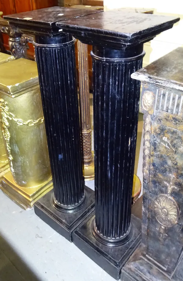 A pair of 20th century ebonised jardiniere stands, with fluted central column and square top, 30cm wide x 123cm high, (2).  M7