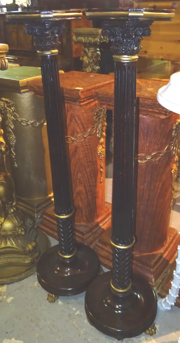 A pair of Regency style gold painted mahogany jardiniere stands, each with fluted central column over circular base, on claw feet, 25cm wide x 120cm h