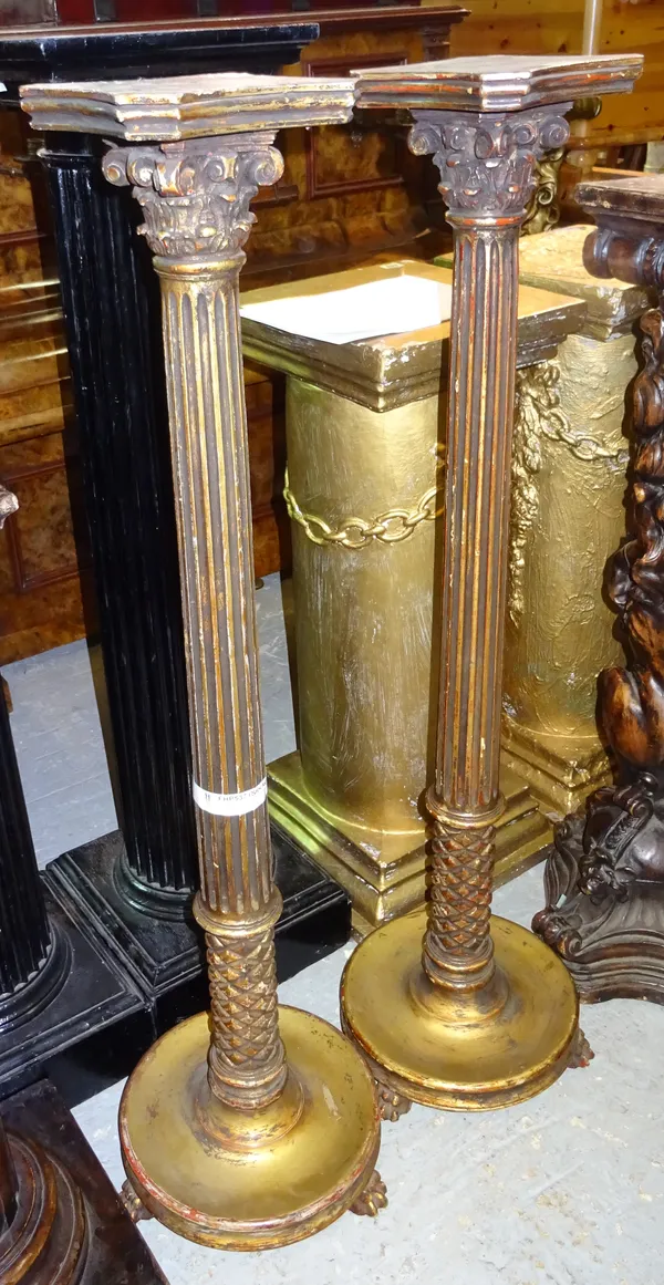 A pair of Regency style gold painted jardiniere stands, each with fluted central column over circular base, on claw feet, 25cm wide x 120cm high, (2).