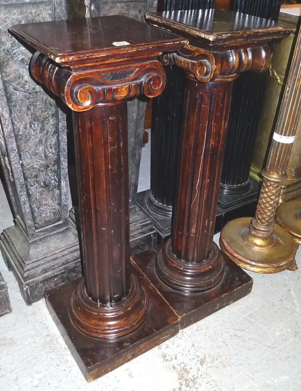 A pair of 20th century Grecian style mahogany jardiniere stands, on fluted central column and plinth base, 30cm wide x 97cm high, (2).  M7