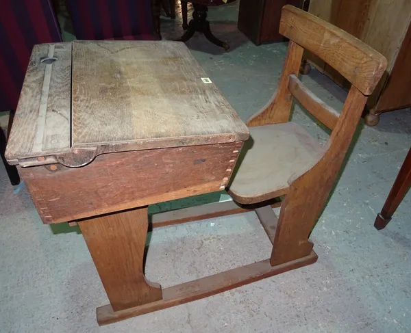 An early 20th century oak student's desk, 57cm wide x 80cm high.  K8