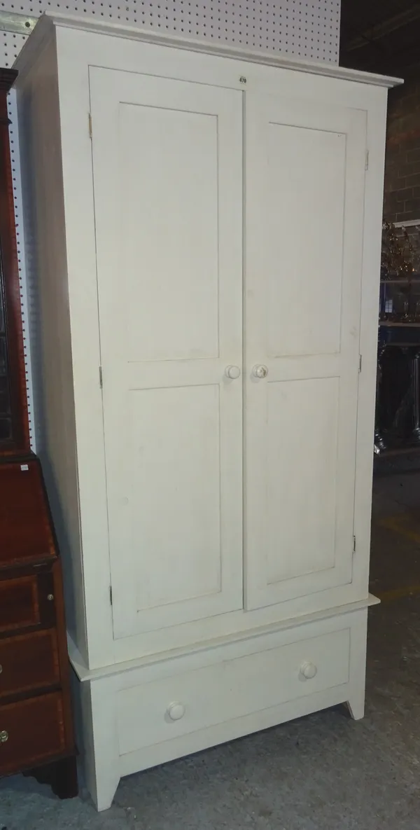 A 20th century white painted single wardrobe, with single drawer base.  M5