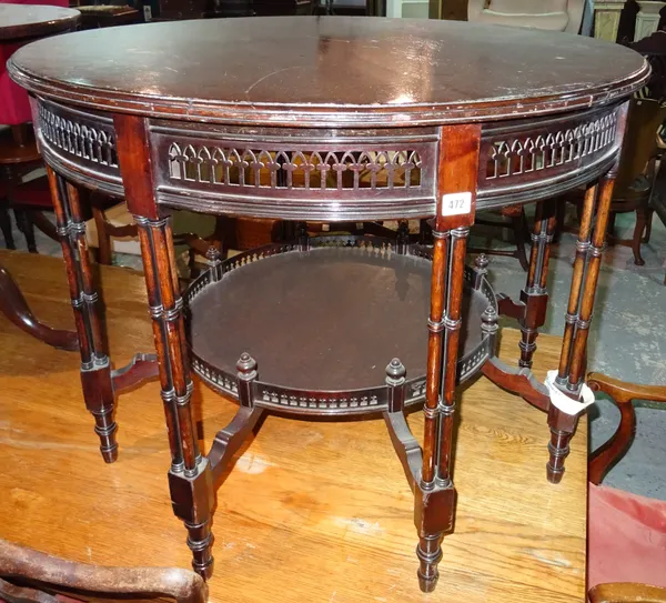 An Edwardian mahogany circular centre table, with fret pierced frieze, on eight cluster column supports united by platform undertier, 92cm diameter x