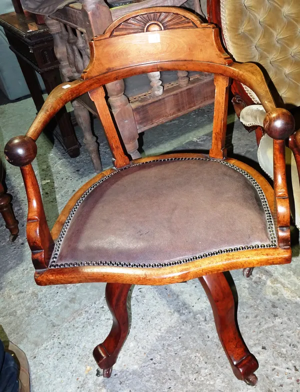 A Victorian walnut captain's open armchair, on four outswept supports.