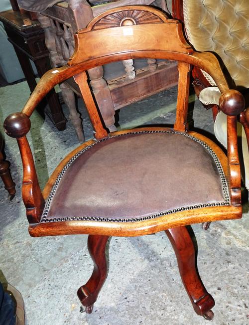 A Victorian walnut captain's open armchair, on four outswept supports.