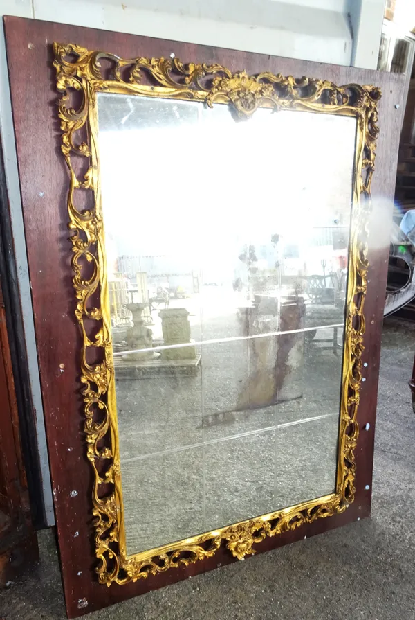 A large 19th century gilt framed mirror of pierced Rococo design, 100cm wide x 150cm high.  A4