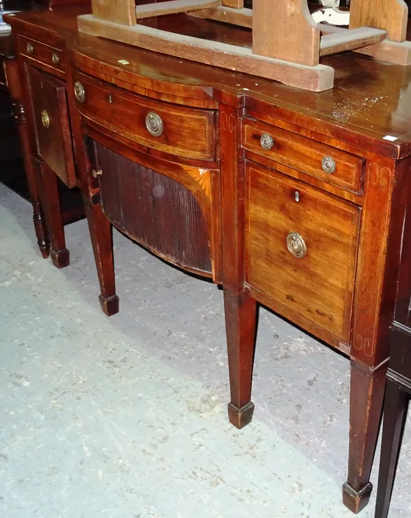 A George III mahogany breakfront sideboard, with sliding tambour front on square tapering supports, 151cm wide x 93cm high.  K7