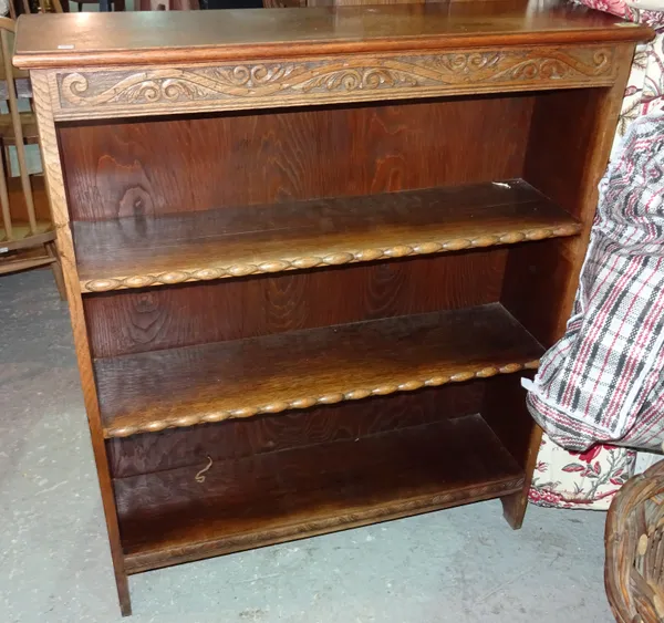 A 20th century oak open bookcase, with three shelves and carved decoration, 91cm wide x 107cm high.  C5