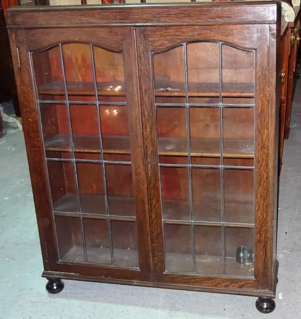A 20th century oak two door glazed bookcase, on turned supports, 89cm wide x 105cm high. EXTRA