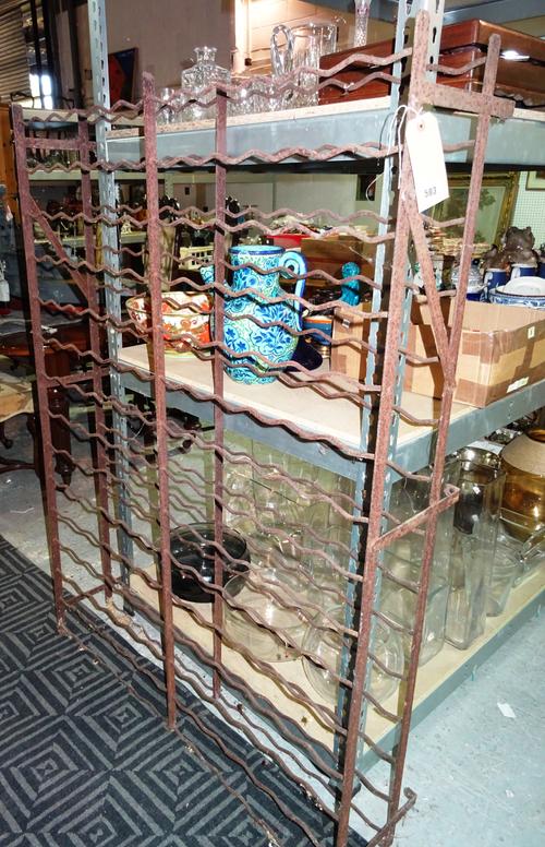 An early 20th century French metal wine rack, of wavy form, 151cm wide x 111cm high.  F2