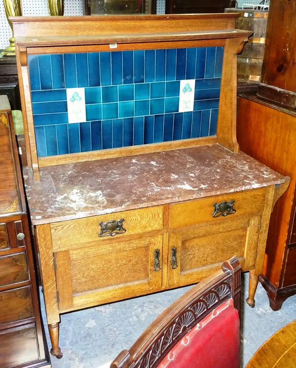 A 20th century Art Nouveau marble top washstand, with tiled back, on tapering supports, 106cm wide x 145cm high.  E9
