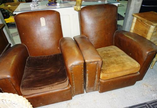 A pair of early 20th century studded red leather low armchairs, (2).  H4