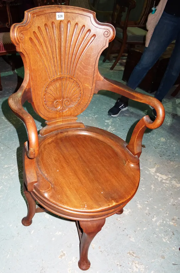 A George II style oak swivel open armchair, with shell back.  G7