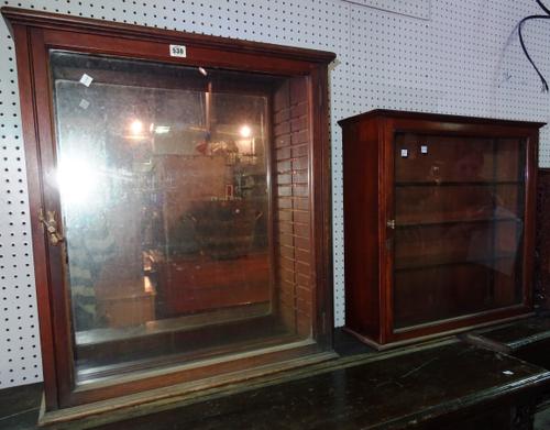 A late 19th century mahogany wall mounted display cabinet with mirrored back and single glazed door, 67cm wide x 76cm high, together with another simi