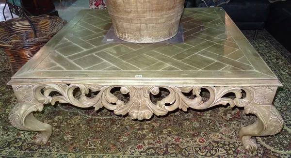 A George II style stained pine coffee table, with floral foliate frieze, on scroll claw feet, 130cm wide x 31cm high.  C4