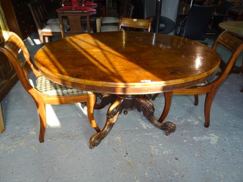 A Victorian walnut tilt top oval loo table, on four carved downswept supports and reeded central column, 100cm wide x 74cm high.  D7