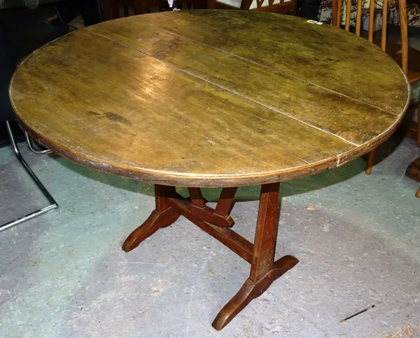 A late 19th century walnut French tilt top wine table, with wedge trestle base, 100cm wide x 73cm high.  C5
