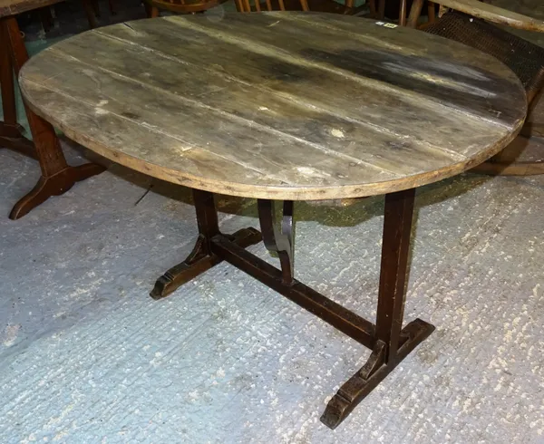 A 19th century walnut French tilt top wine table, with circular top on wedge trestle base, 98cm wide x 65cm high.  B5
