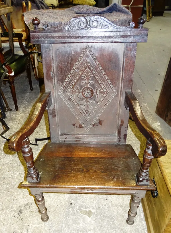 A 17th century and later oak panel back open armchair, with solid seat on turned supports, 70cm wide x 107cm high.  EXTRA