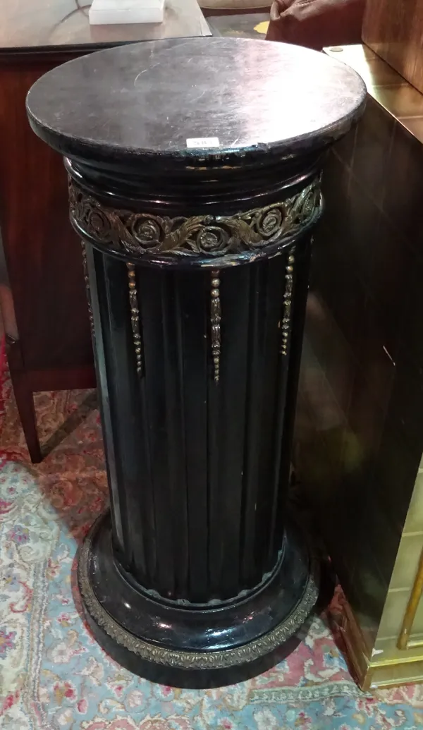 A Regency style ebonised gilt metal mounted jardiniere stand, with fluted central column on circular plinth base, 39cm wide x 93cm high. E2