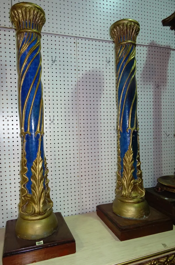 A pair of Regency style blue painted jardiniere stands with gilt foliate decoration, 17cm wide x 119cm high, on plinth base, (2).   C10
