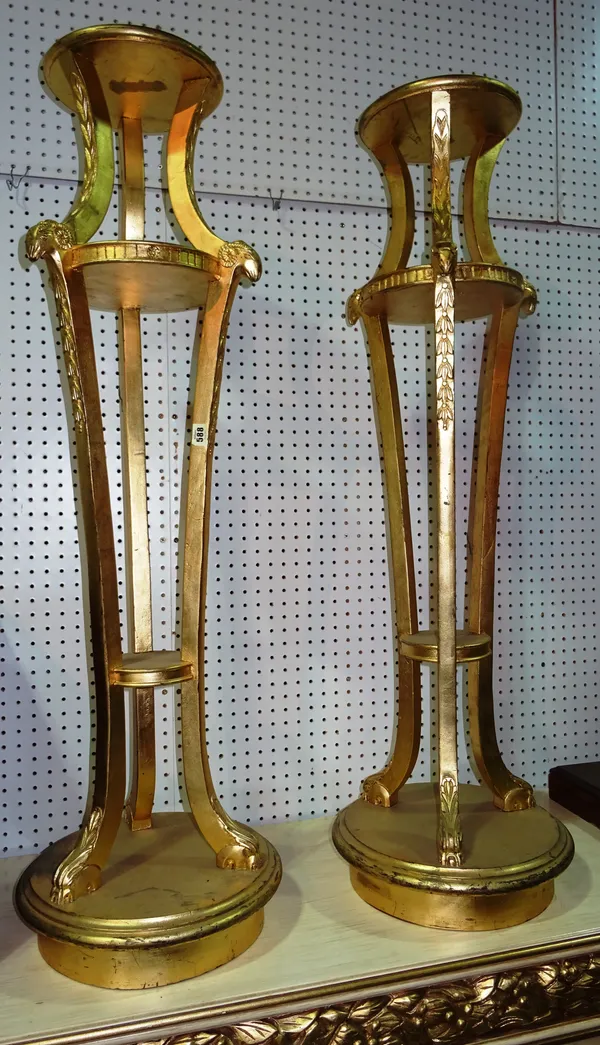 A pair of George III style gold painted jardiniere stands, on three downswept supports, with rams head decoration on plinth base, 24cm wide x 124cm hi