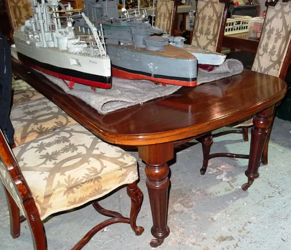 A late Victorian mahogany extending dining table on turned tapering fluted supports, two extra leaves and winder, 121cm wide x 146cm long x 242cm long