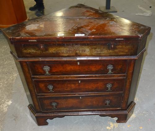 An 18th century style feather banded walnut corner bureau, the lift top enclosing a fitted interior, over three drawers, on bracket feet,87cm wide x 7