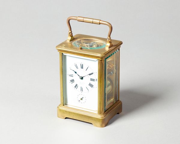 A French brass carriage clockCirca 1910In a corniche case with push/repeat, the white enamel dial inscribed GOLDSMITHS & SILVERSMITHS COMPANY 112 REGE