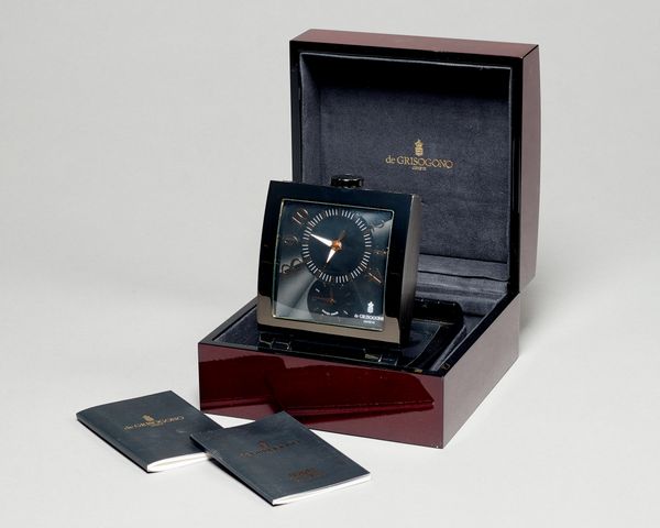 A Modern Swiss quartz dual time timepieceBy de GrisogonoThe shaped rectangular patinated metal case with angled mount, with engine-turned dial10 cm. w