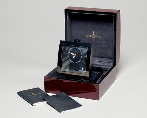 A Modern Swiss quartz dual time timepieceBy de GrisogonoThe shaped rectangular patinated metal case with angled mount, with engine-turned dial10 cm. w