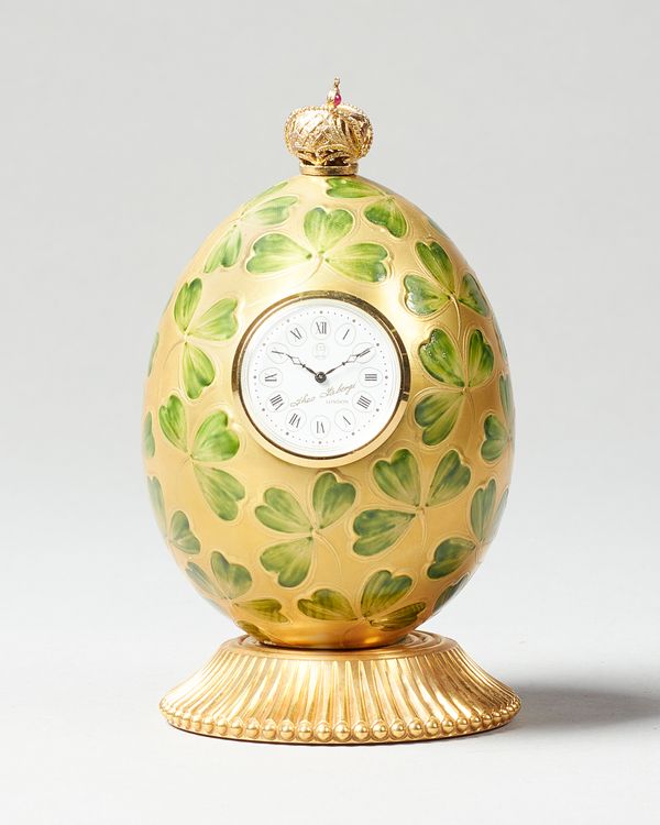 A Modern giltmetal and enamel Clover Egg timepieceBy Theo Faberge, England, No. 187 of 750The egg-shaped case surmounted by a crown, above green ename