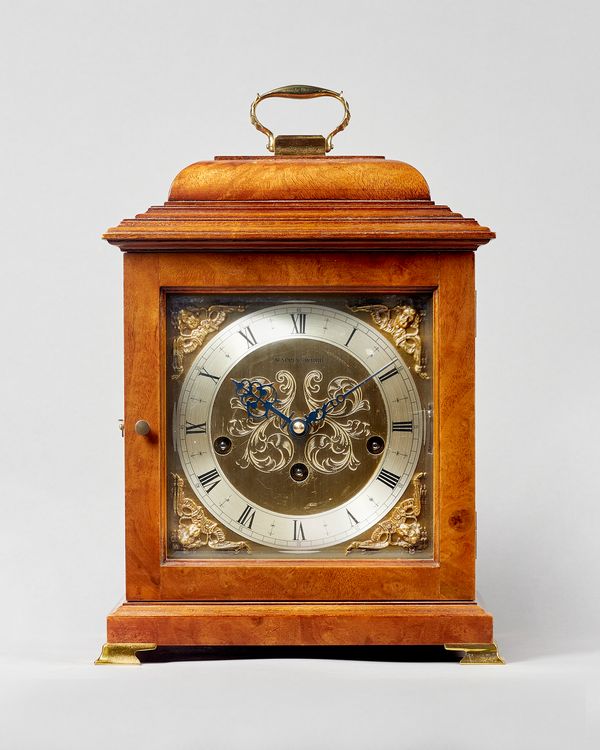 A Modern walnut cased chiming bracket clockRetailed by Mappin & Webb, By Kieninger, Germany, for Comitti, LondonThe case with a stepped domed pediment
