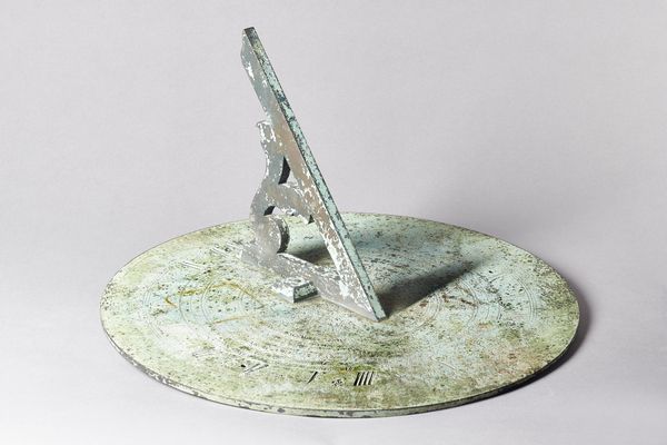 A George III patinated bronze sundial plateBy Thomas Wright, London, circa 1800The 18in. dial, finely engraved, with pierced gnomen, calibrated with t
