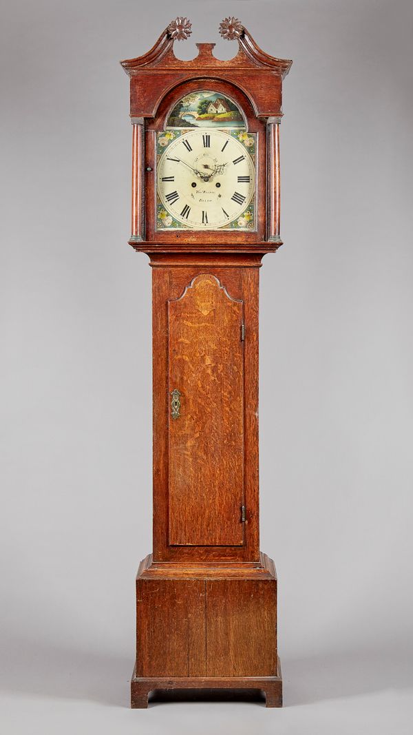 An oak longcase clockBy Thomas Waldie, Blyth, circa 1835The case with a swan neck pediment and sunflower terminals, above turned pillars, the trunk in