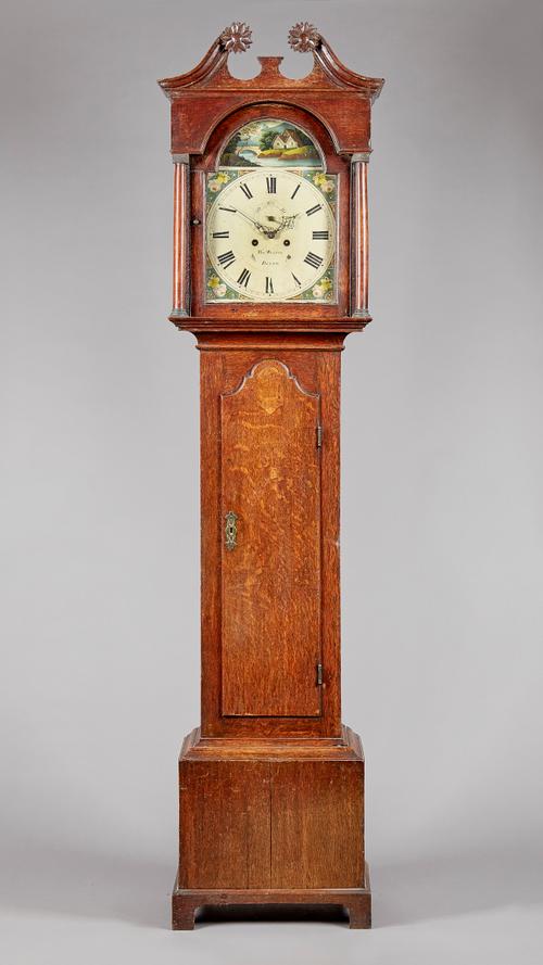 An oak longcase clockBy Thomas Waldie, Blyth, circa 1835The case with a swan neck pediment and sunflower terminals, above turned pillars, the trunk in
