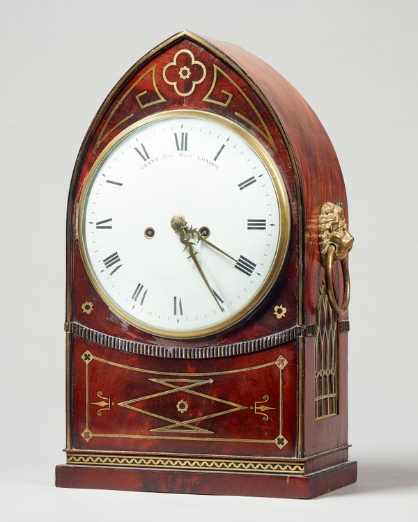 A Regency mahogany and brass line inlaid lancet-shaped mantel clockRetailed by John Grant, Fleet Street, London, the movement by Handley & Moore, No.