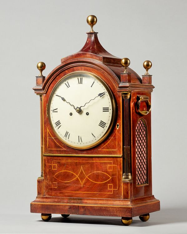 A George III mahogany and boxwood line inlaid bracket clockBy John Wilson, Peterboro, circa 1800The broken arched case with central chamfered pediment