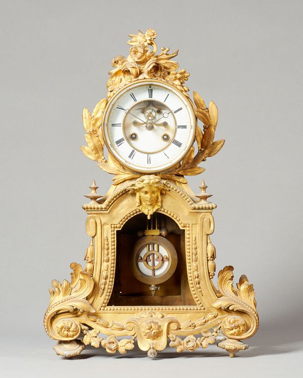 A French giltmetal mantel clockcirca 1870The case surmounted by a floral spray above the glazed bezel, the white enamel dial with visible Brocot escap