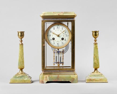 A French giltbrass, enamel and green onyx four glass mantel clock garniturecirca 1910The clock, with a stepped pediment above a glazed front and back