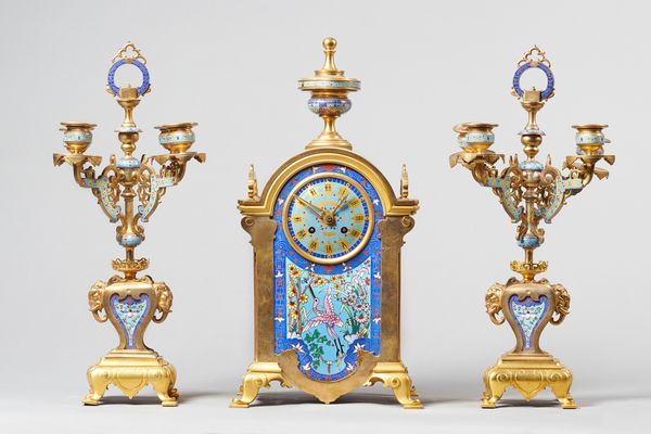 A French Orientalist ormolu and champleve clock garniturecirca 1880Comprising a clock and a pair of four-light candelabra, the clock surmounted by a f