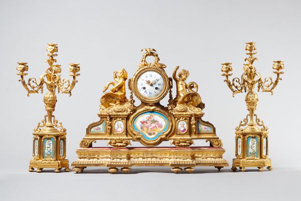 A Napoleon III ormolu and Sèvres style mounted clock garnitureSigned Pepin, A Paris, circa 1860The clock modelled with a pair of putto riding swans, b