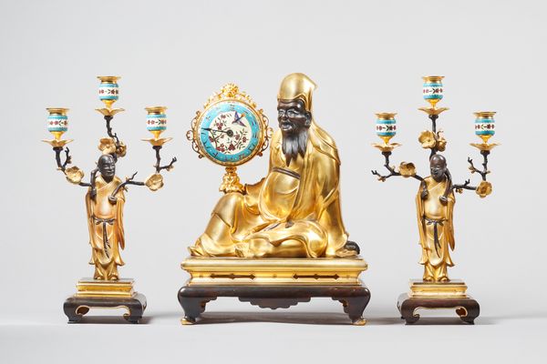 A French 'Japonisme' ormolu, bronze and cloisonne enamel clock garniturecirca 1890Comprising the clock and a pair of three-light figural candelabra; t