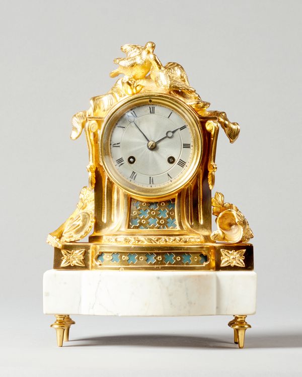 A Napoleon III ormolu and white marble mantel clockIn the Louis XVI style, circa 1865The re-gilt case modelled with two doves, above the dial and flan