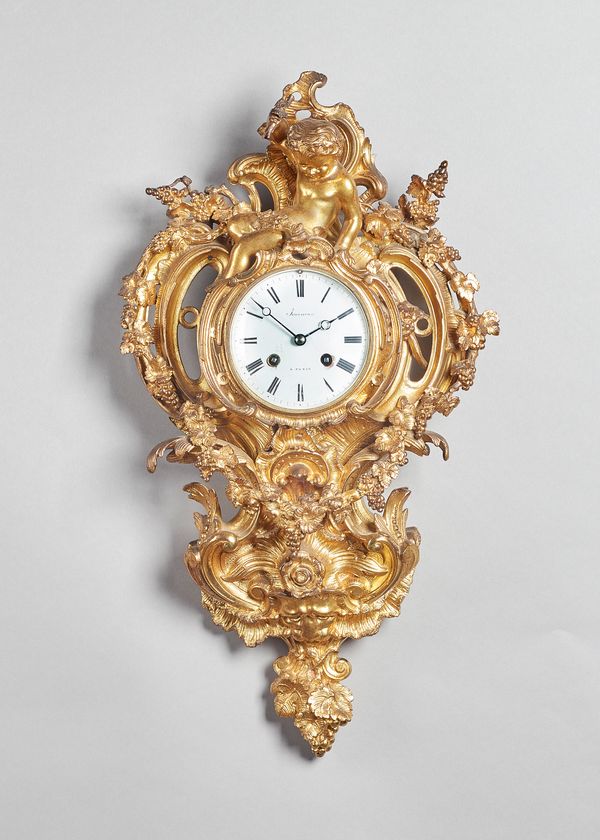 A Napoleon III ormolu cartel clockIn the Louis XV style, circa 1865The case of shaped outline, surmounted by a seated cheub and cast with vine ornment