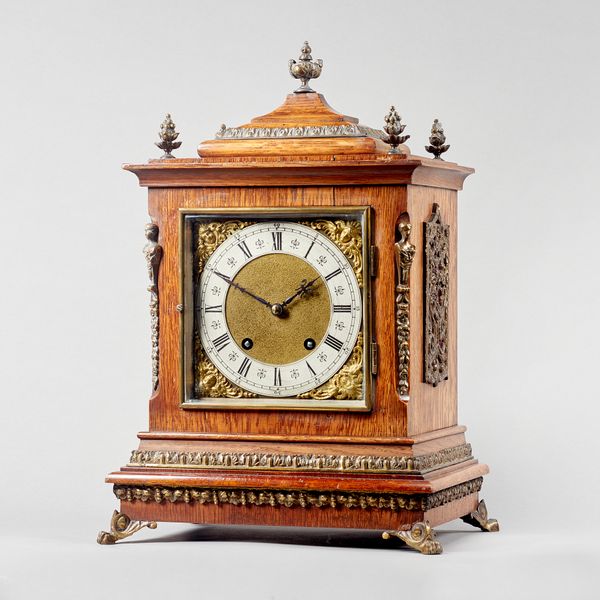 A German giltmetal-mounted oak cased quarter striking mantel clockBy Lenzkirch, circa 1890The case with a stepped pediment above 6 ½ in. square brass