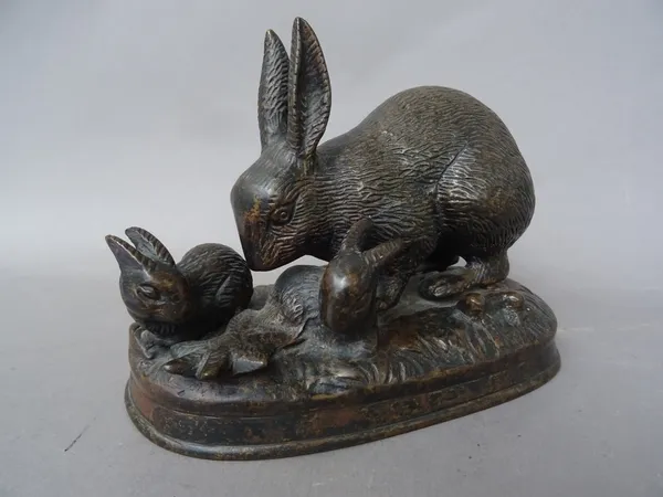A 20th century patinated bronze rabbit group, modelled on a naturalistic shaped base, 16cm wide.