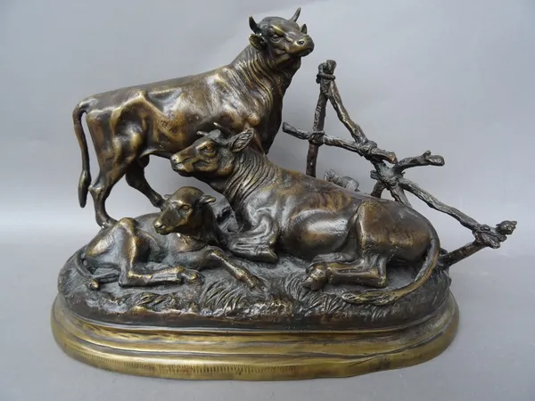 After Jules Moigniez; a French bronze cattle group on a naturalistic shaped base, signed 'Moigniez' to the cast, 30cm wide.