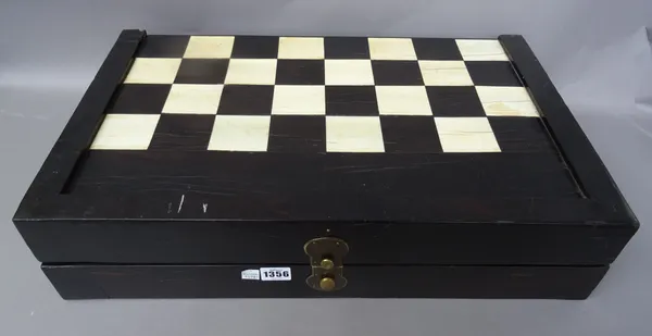 An Anglo-Indian stained ivory folding chess and backgammon board, late 19th century, with circular stained ivory counters, 73cm x 58cm.
